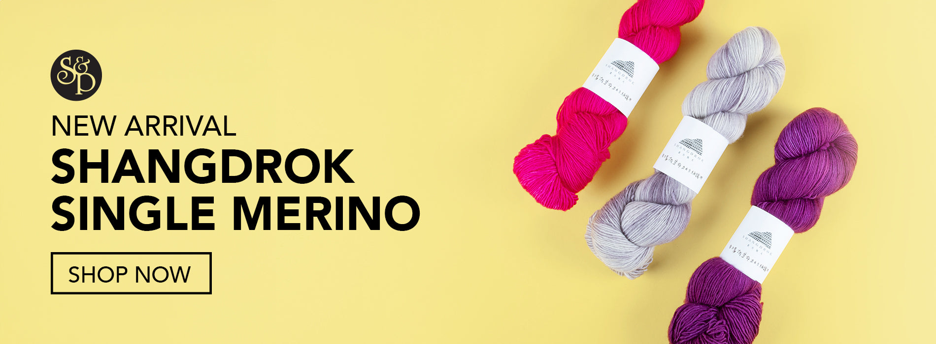 This image advertises that the base "Single Merino" from the brand Shangdrok has newly arrived at Stephen & Penelope. The text includes a "shop now" button and the S&P black logo. The image shows three skeins of Shangdrock yarn in pink., grey, and purple on a light yellow background. 