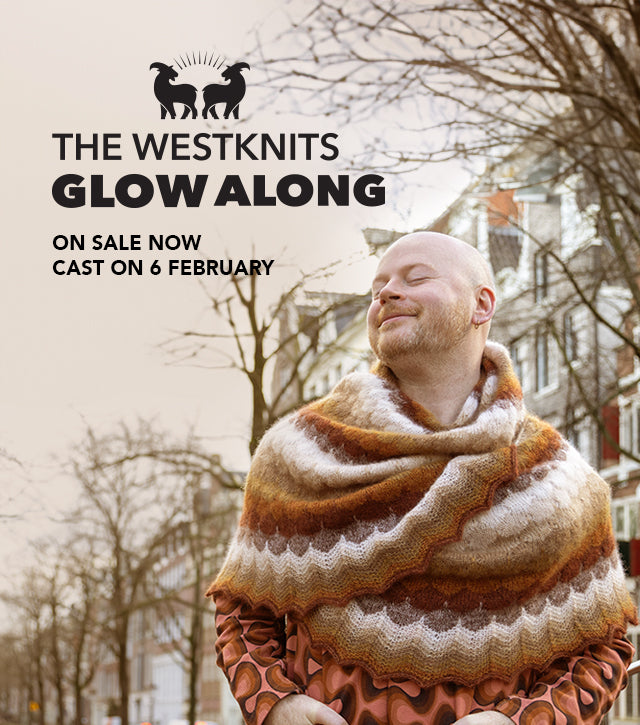 This image advertises "The Westknits Glow Along," with details about it going on sale now and starting on February 6. It features Stephen West wearing a beautifully knitted shawl in warm, earthy tones. The background shows a tree-lined street, and the text includes a the West Wool Glowhair logo.